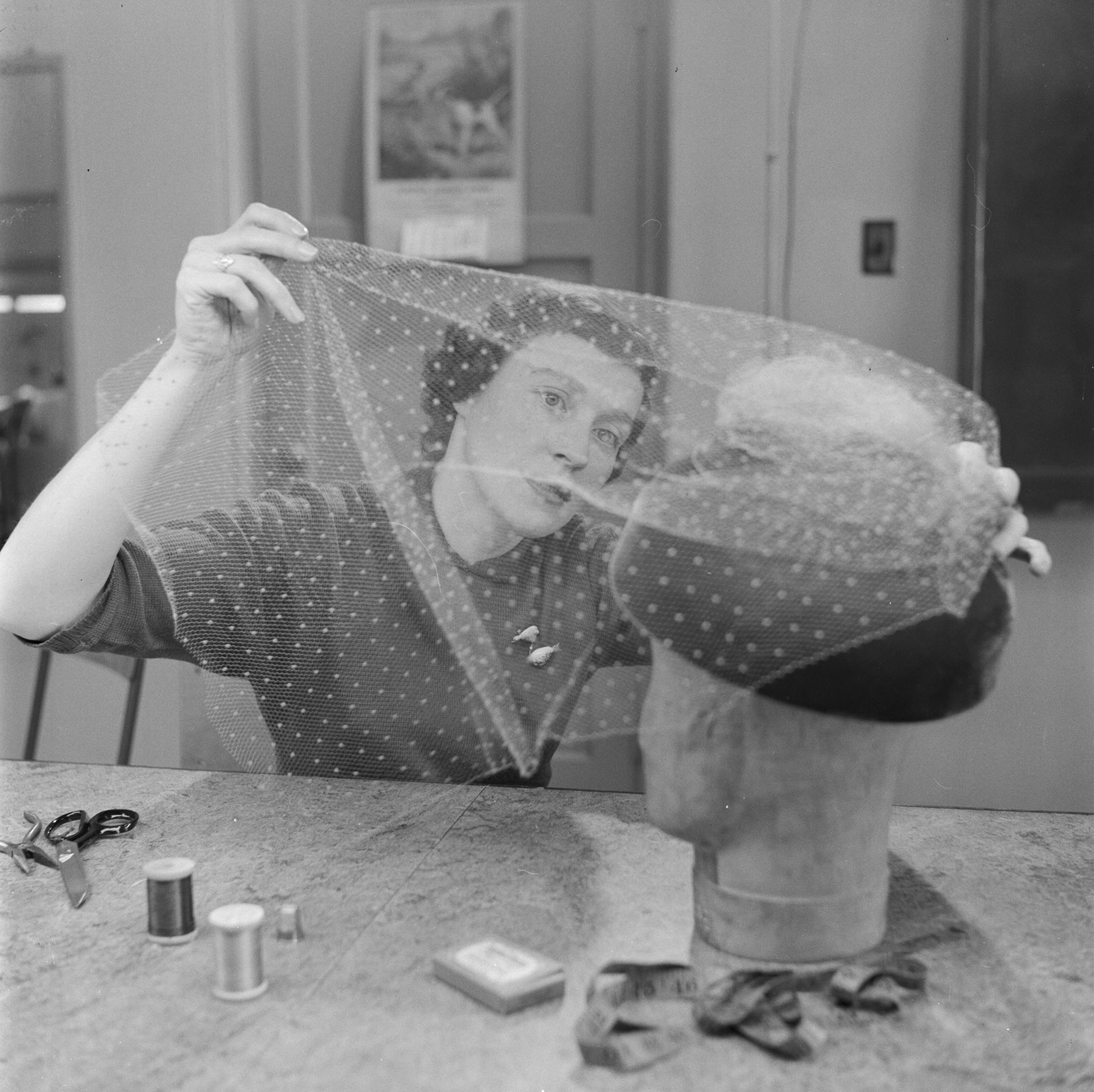 Woman at millinery school working on a hat